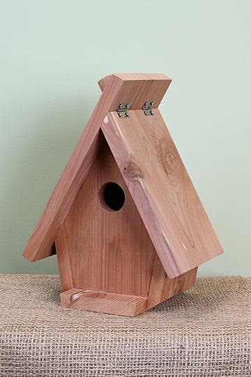 Triangular bird house shape. Large roof lifts on the one side. Red cedar wood constuction.