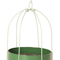 Green circular tray with seeds inside. Has 6 white poles that meet in the center to hook onto the hanger.
