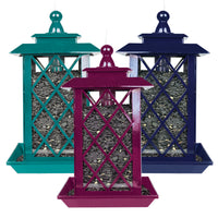 Turquoise lantern style feeder on the left, purple lantern style feeder in the middle, and dark blue latern style feeder on the right.