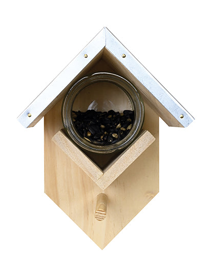 Clear jar under a roof in the middle of the feeder is filled half-way with seeds.