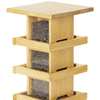 Condo style wood feeder. Has 3 levels of trays and windows. Filled with seeds at each window.