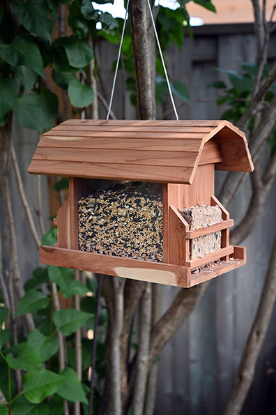 Shaped like a barn, it is red coloured wood with the center filled with seeds and each end holds suet cakes.