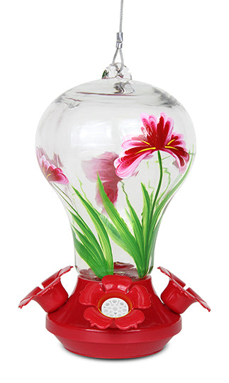Glass has pink flowers on it. Base is red and circular with red flower shaped feeding holes.
