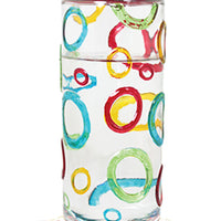 Red circular lid and base. Base has white flower shaped feeding holes. Glass has blue, red, yellow, and green coloured rings on it.