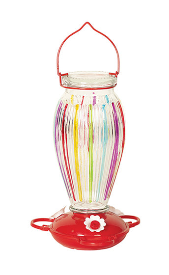 Glass vase shape. Purple, red, yellow, green, and blue stripes on the glass. Red circular base with white flower shaped feeding holes.