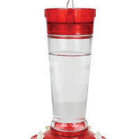 Red circular lid, clear glass middle to see the nectar, red circular base with white flower feeding holes.