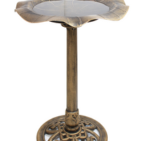 A gold tall birdbath.
