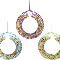 Blue wreath shaped feeder on the left, purple wreath shaped feeder in the centre, green wreath shaped feeder on the right.