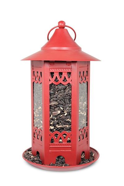 Red filled with sunflower seeds, tray at the bottom to catch the seeds.