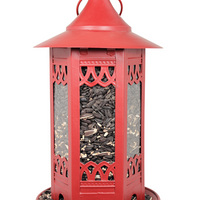 Red filled with sunflower seeds, tray at the bottom to catch the seeds.