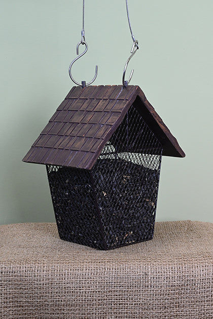 House shaped feeder. Mesh bottom filled with seeds. Shingle styled roof.