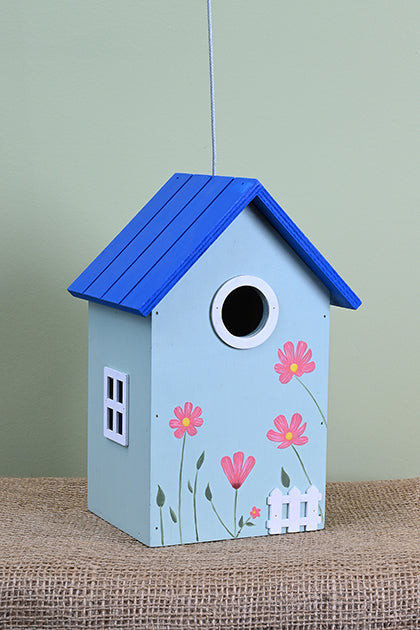 Blue birdhouse with pink flowers.