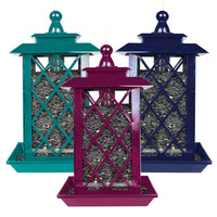 Turquoise lantern style feeder on the left, purple lantern style feeder in the middle, and dark blue latern style feeder on the right. 