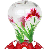 Glass has pink flowers on it. Base is red and circular with red flower shaped feeding holes.