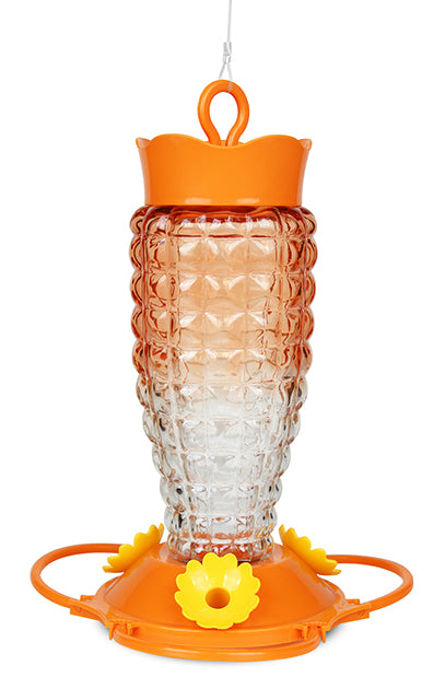Orange lid and base. Base has yellow flower shaped feeding holes. Glass has a bubble-like texture, the colour is ombre orange to clear.