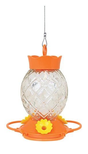 Oval shaped glass with diamond pattern. Orange lid and base, base has yellow flower shaped feeding holes.