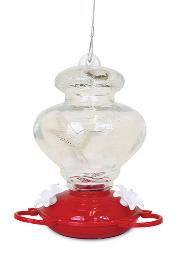 Glass has a hummingbird embossed into it. Red circular base with white flower shaped feeding holes.