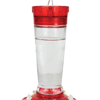 Red circular lid, clear glass middle to see the nectar, red circular base with white flower feeding holes.