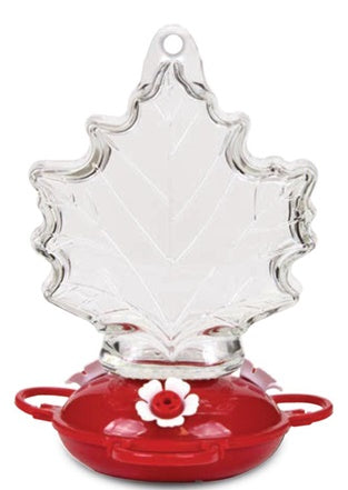 Maple leaf shaped glass, red circular base with white flower shaped feeding holes.