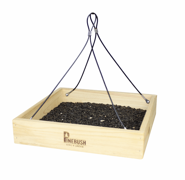 Wooden tray with seeds inside. 4 strings from each corner that meet in the middle at the top to hang the feeder.