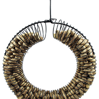 Black wreath shaped feeder filled with shelled peanuts.